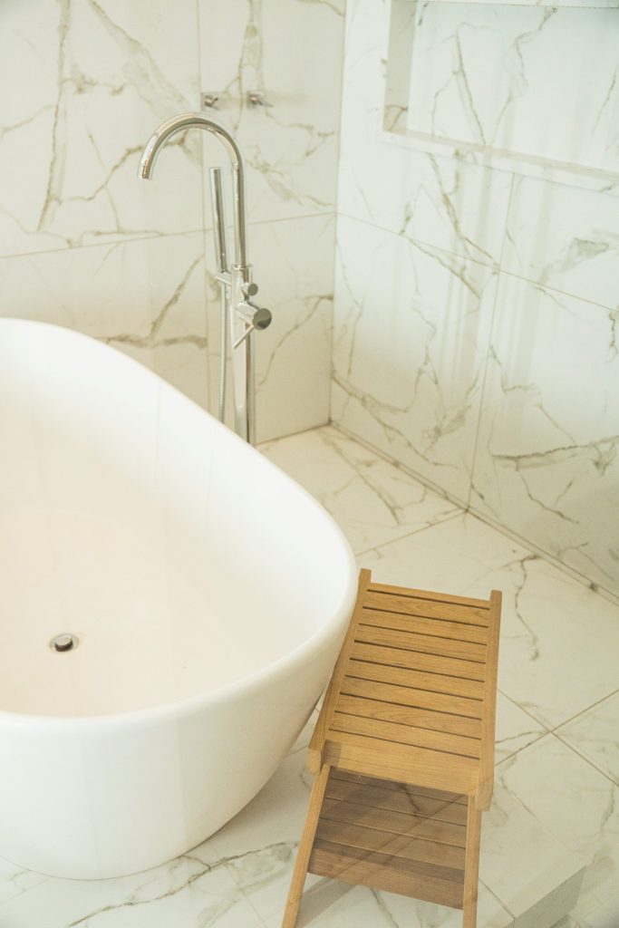 a bathtub and a chair in a bathroom